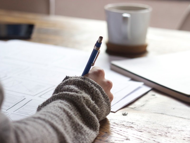 Professional technical writing and document analysis on laptop